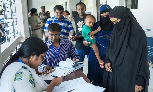 People get their names checked in voters' list as they arrive to cast votes during the by-elections to Boxanagar assembly seat, in Tripura's Sepahijala district