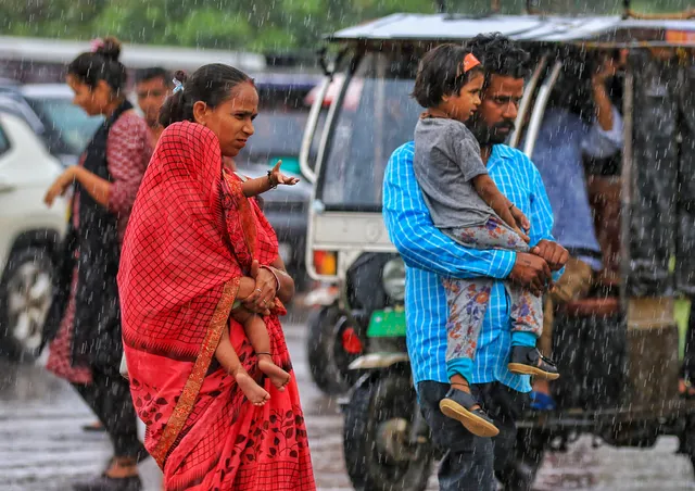 Pedestrians during rainfall, in Jaipur