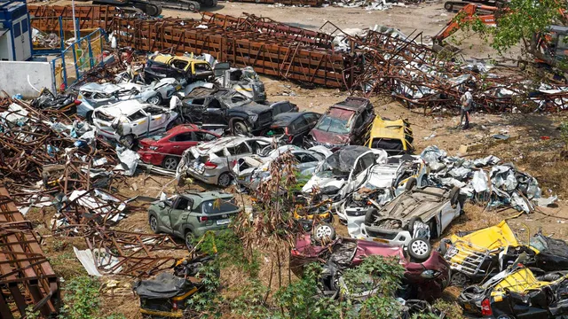 Wreckage of the vehicles that were damaged after a 100-foot tall illegal billboard fell on a petrol pump on Monday due to rains and dust storm, in Ghatkopar area of Mumbai, Thursday, May 16, 2024