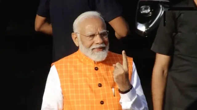 Narendra Modi shows his inked finger after casting his vote at a polling booth in Ahmedabad, Gujarat