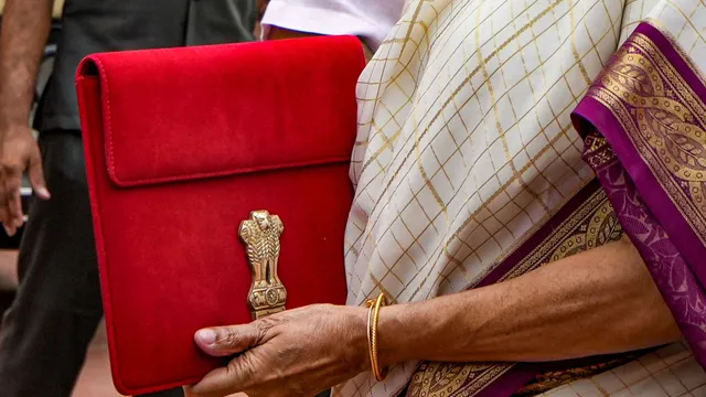 Union Finance Minister Nirmala Sitharaman with a red pouch carrying the Budget documents arrives at the Parliament to present the Union Budget 2024-25, in New Delhi, Tuesday, July 23, 2024.