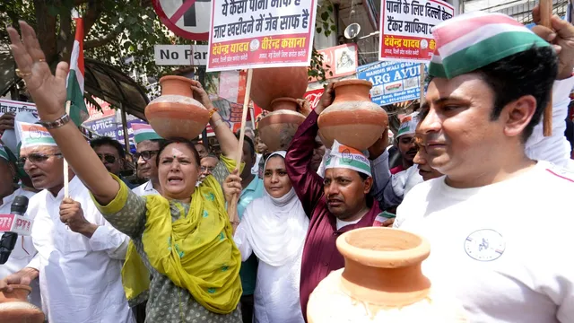 Congress workers carry earthen pots during a 'Matka Phod' protest against the ongoing water crisis, in New Delhi, Saturday, June 15, 2024.