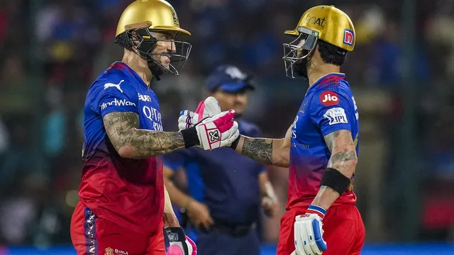 Royal Challengers Bengaluru batter Faf du Plessis being greeted by Virat Kohli on his fifty during the IPL 2024 match between RCB and Gujrat Titans at M. Chinnaswamy Stadium in Bengaluru on May 4, 2024