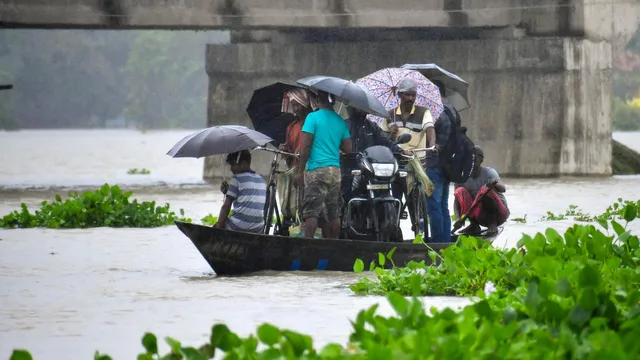 Villagers use a boat to travel across a flood affected area after heavy rainfall, in Morigaon district, Tuesday, July 2, 2024.