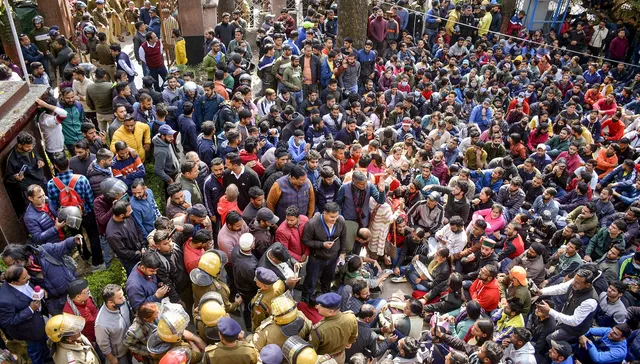 Youths stage a protest at Shaheed Smarak in district court premises against police action during Thursday's protest over alleged irregularities in state government recruitment examinations in Dehradun on Friday