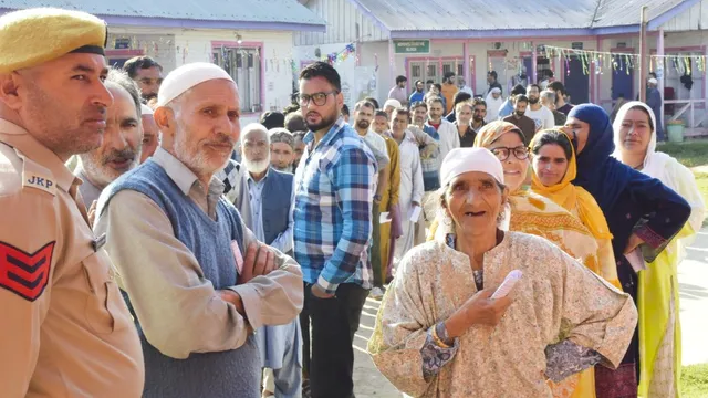 Voters stand in a queue to cast votes during the first phase of Jammu and Kashmir Assembly elections, in Pulwama district