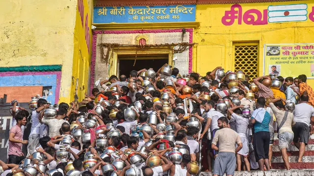 Devotees arrive to perform 'Jalabhishek' ritual on the first Monday of Sawan month, at Shree Gauri Kedareshwar Mandir in Varanasi, Monday, July 22, 2024.