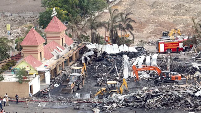 Debris being removed from the game zone site where a major fire on Saturday evening killed at least 27 people and injured three, in Rajkot, Sunday, May 26, 2024