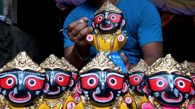 An artist gives finishing touches to an idol of Lord Jagannath ahead of the Rath Yatra festival, in Nadia district, Thursday, July 4, 2024.