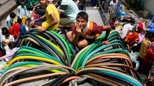 Residents collect drinking water from a tanker amid ongoing water crisis at Vivekananda Colony, Chanakyapuri, in New Delhi, Thursday, May 30, 2024