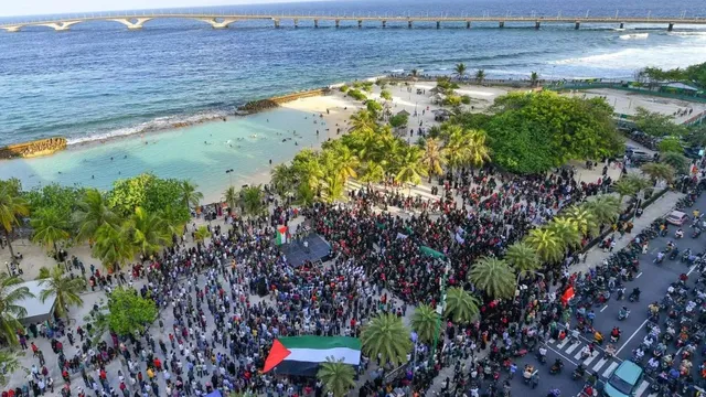 Demonstrators gather to show solidarity with Palestinians during a rally held in the artificial beach region in the capital city of Male on 14 October