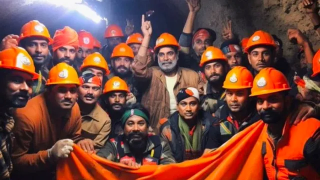 Rescue officials pose for group photos after the successful evacuation of 41 workers from the collapsed Silkyara Tunnel, in Uttarkashi district, Tuesday, Nov. 28, 2023.