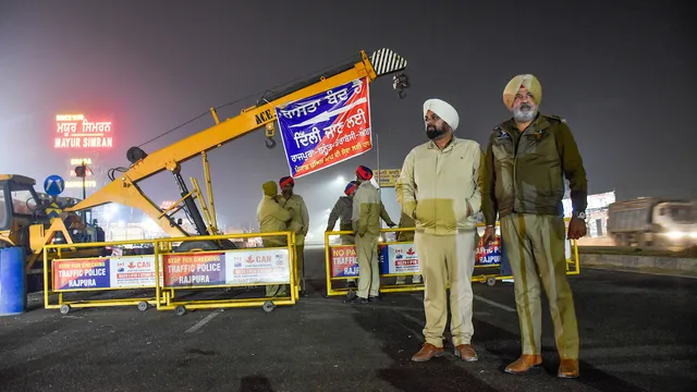 Police personnel stand guard during traffic restrictions near Shambhu Border ahead of the scheduled march by the protesting farmers towards Delhi, at Rajpura, in Patiala district, Monday, Feb. 12, 2024.