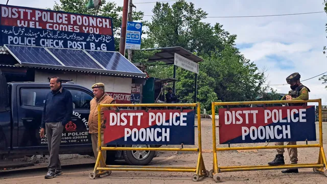 Security personnel stand guard at a police blockade at Bhimber Gali sector on April 22, near the site of Thursday's terror attack in which five army personnel were killed, in Poonch district