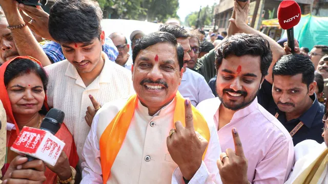 Madhya Pradesh Chief Minister Mohan Yadav with family members shows his inked finger after casting his vote during the fouth phase of Lok Sabha elections, in Ujjain, Monday, May 13, 2024