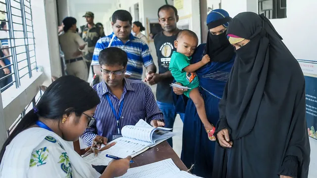 People get their names checked in voters' list as they arrive to cast votes during the by-elections to Boxanagar assembly seat, in Tripura's Sepahijala district, Tuesday