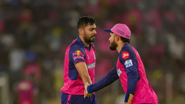 Rajasthan Royals' Avesh Khan with his teammate celebrates the wicket of Royal Challengers Bengaluru player Mahipal Lomror during the Indian Premier League (IPL) 2024 T20 cricket match