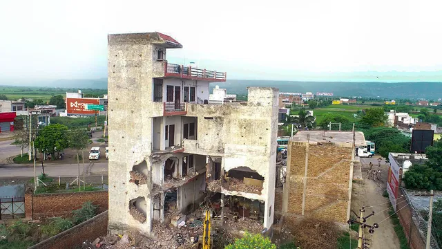 Authorities demolish the Sahara Family restaurant from where hooligans allegedly pelted stones on a religious procession on July 31 which led to violence, in Nuh, Sunday, Aug. 6, 2023. The building was demolished in administration's drive against illegal constructions