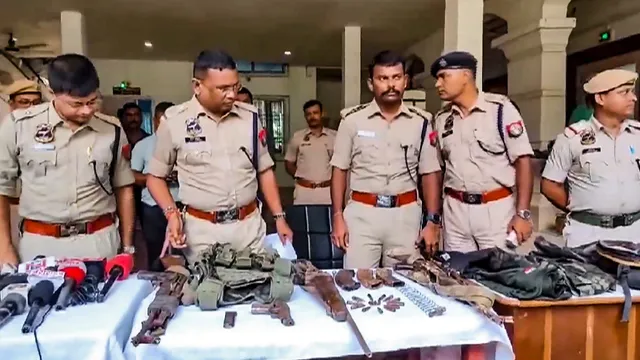 Police personnel display the arms and ammunition recovered after an encounter with alleged Hmar terrorists, in Cachar district of Assam, Wednesday, July 17, 2024.
