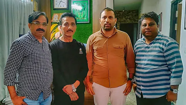 Mumbai Police Crime Branch personnel with the Director of Ego Media Pvt Ltd Bhavesh Bhinde (in black) after arresting him