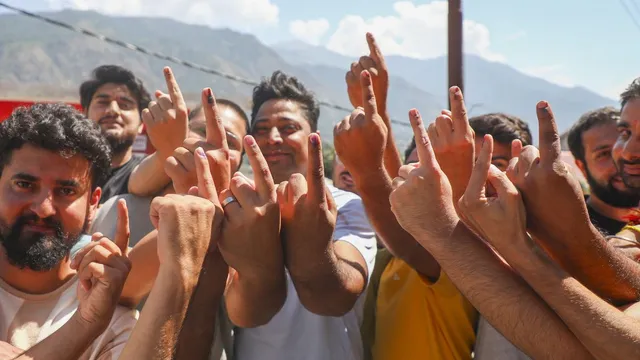 Voters show their fingers marked with indelible ink after casting votes during the first phase of Jammu and Kashmir Assembly elections, in Kishtwar, Wednesday, Sept. 18, 2024