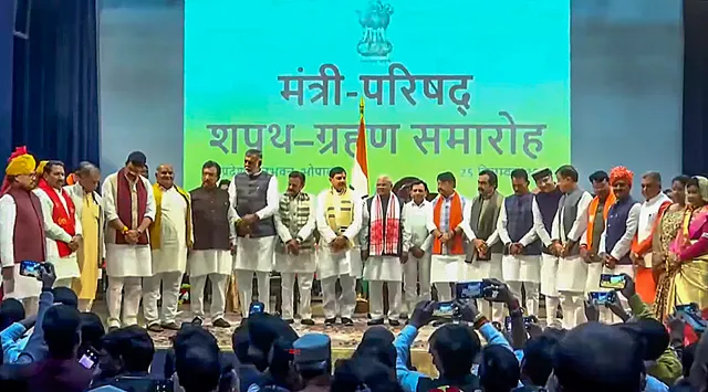 Madhya Pradesh Governor Mangubhai Patel and Chief Minister Mohan Yadav pose for a group photo with the newly inducted ministers of the State Cabinet, after the swearing-in ceremony at Raj Bhawan, in Bhopal, Monday, Dec. 25, 2023