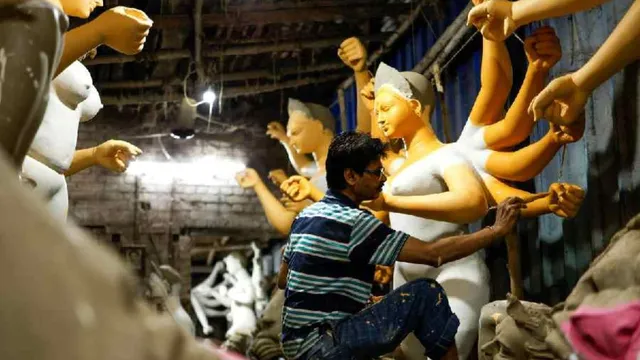 An artisan paints an idol of the Hindu goddess Durga inside a workshop ahead of the Durga Puja festival in Calcutta