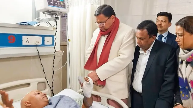 Pushkar Singh Dhami meets a man who was injured in the violence that erupted after the demolition of an 'illegally built' madrasa, in Haldwani, Friday, Feb. 9, 2024.