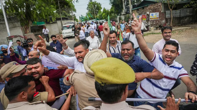 Police personnel try to stop Peoples Democratic Party (PDP) workers protesting over the recent terror attacks in J&K, in Jammu, Friday, June 14, 2024.