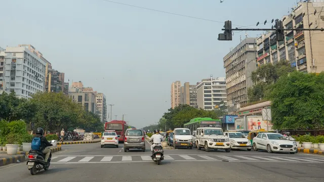 Vehicles move down a road amid clear weather conditions, in New Delhi