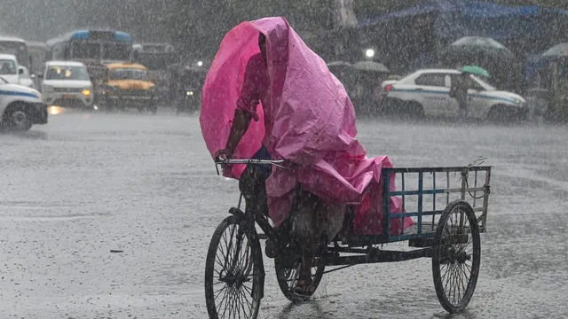 A man rides his cart during heavy rains, in Kolkata, Saturday, June 29, 2024.