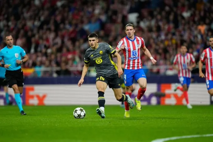 A Lille player racing with the ball against atletico in the Champions League. Sportz Point.com