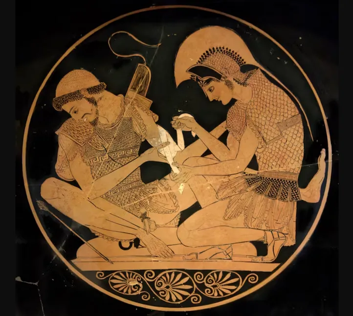 A depiction from a vase (circa 500 BC from Vulci) showing Achilles tending Patroclus, who is wounded by an arrow. Wikimedia