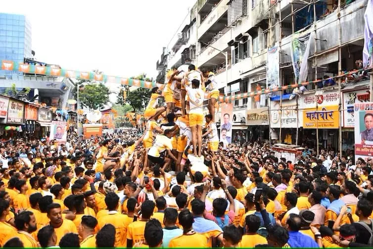 Young Hindu devotees break a dahi-handi, or curd pot, suspended from a rope. 