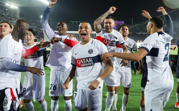 Mbappe celebrating with his PSG teammates after knocking Barcelona out of the competition