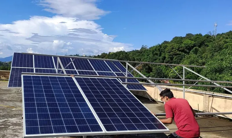 A technician instaling a solar panel