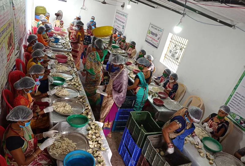 tribal women working at the processing facility