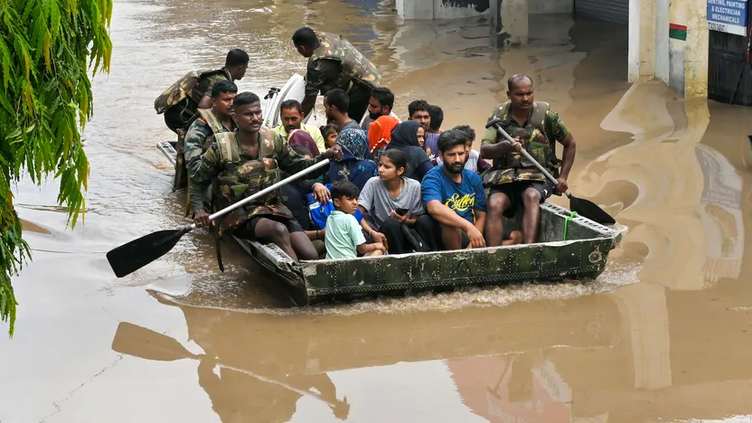 Indian Army personnel rescue people stuck in a flooded residential area after an increase in the water level of Badi Nadi river following heavy monsoon rain, in Patiala, Tuesday, July 11