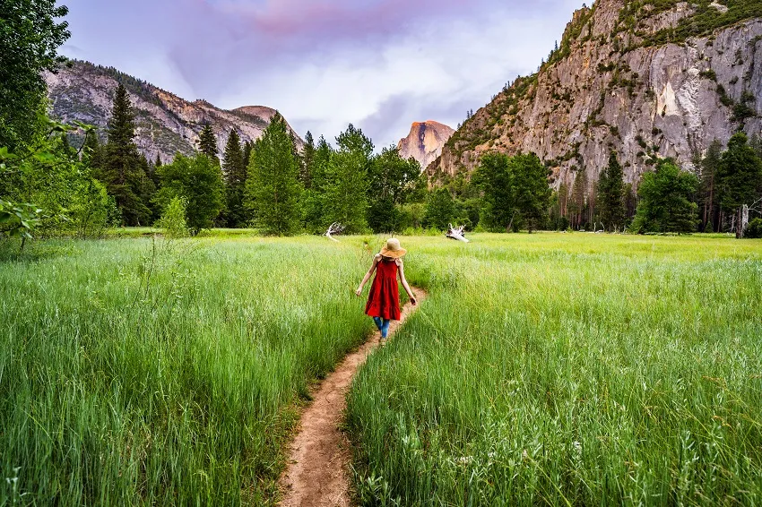 Yosemite_GirlWalkingThroughValleyFloorAtSunset_Credit Visit California & David H. Collier