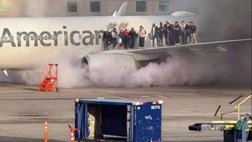 Passengers evacuate Onto Wing as American Airlines plane catches fire in Denver