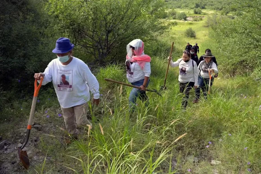 Members of the Madres Buscadoras de Sonora search for the remains of missing persons on the outskirts of Hermosillo, a city in northwestern Mexico, in 2021. Alfred Estrella/AFP via Getty Images