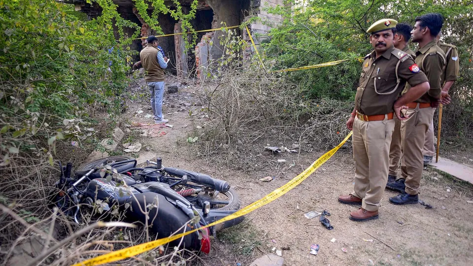 Policemen on the spot where Arbaaz, suspect in Umesh Pal's killing, was killed in an encounter in Prayagraj on Monday