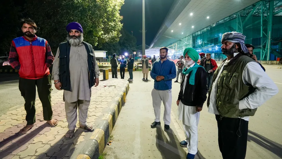 Relatives wait outside the airport ahead of the second batch of the immigrants' arrival from the US in Amritsar on Saturday, Feb. 15,