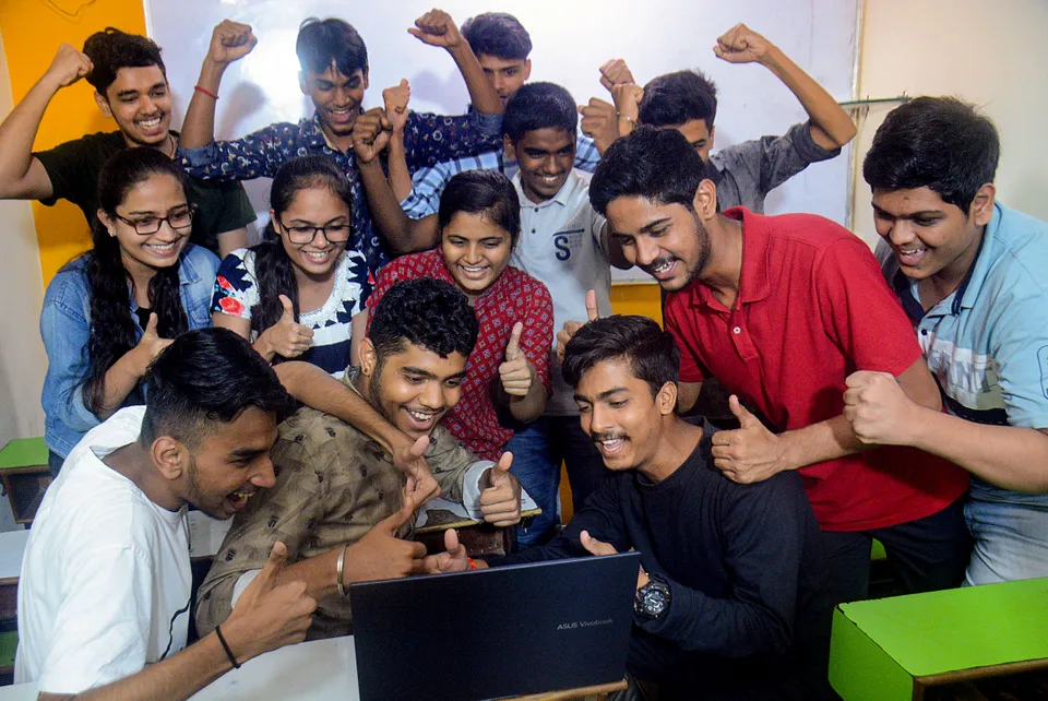 Students celebrate their success after declaration of Maharashtra HSC examination results, in Thane