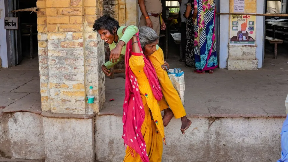 Raat Rani with her physically challenged daughter 27-yr old Kamla after casting votes at a polling booth during the third phase of Lok Sabha elections, in Hathras, Tuesday, May 7, 2024