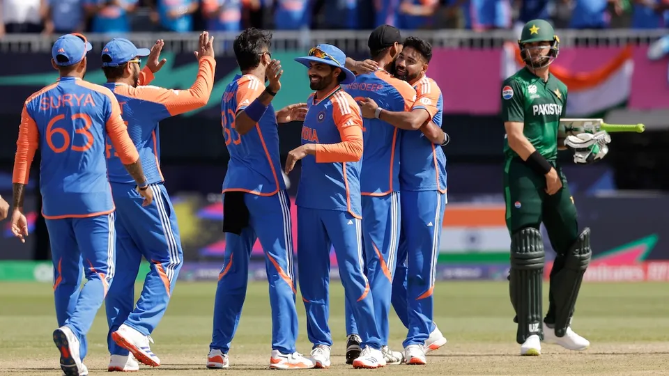 Shaheen Shah Afridi, right, watches as Indian players celebrate their win in the ICC Men's T20 World Cup cricket match between India and Pakistan at the Nassau County International Cricket Stadium in Westbury, New York, Sunday, June 9, 2024.