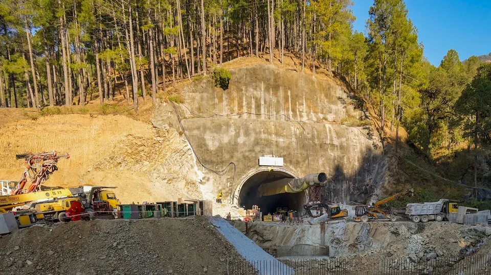 Security personnel and others at the under-construction Silkyara tunnel