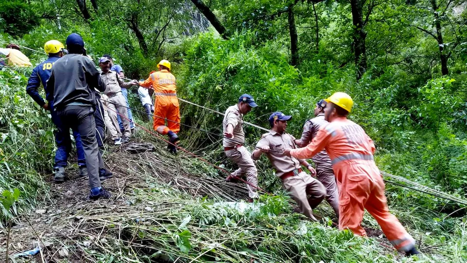 NDRF and SDRF personnel rescue passengers after a bus fell into a gorge near Gangotri National Highway, in Uttarkashi district, Sunday, Aug. 20, 2023. At least 7 people were killed and several others suffered injuries in the accident, according to officials.