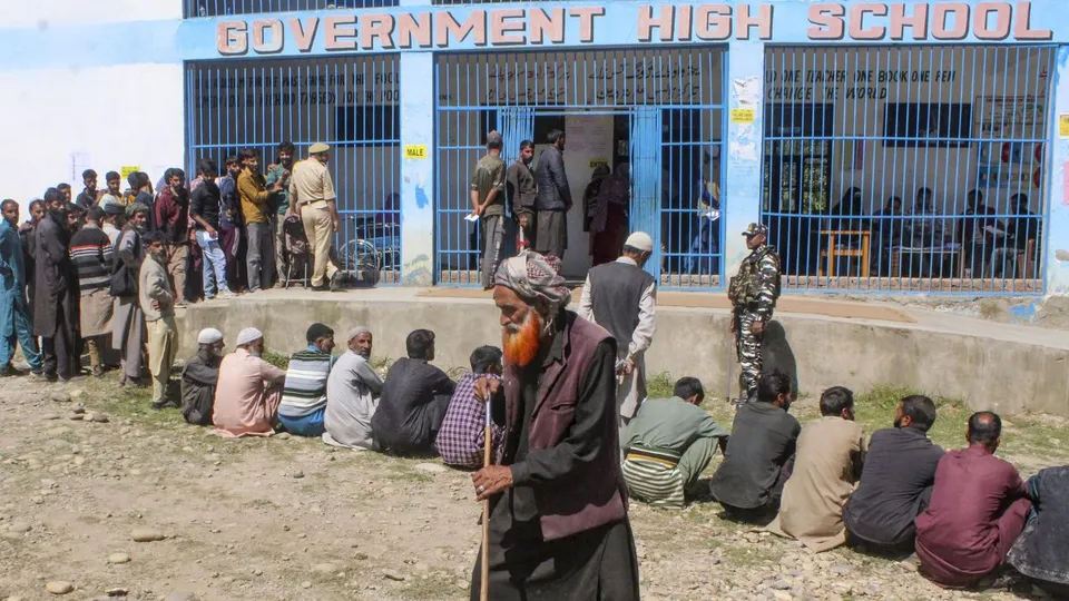 Voters wait in a queue at a polling station during the first phase of Assembly elections, in Shopian district of south Kashmir, Wednesday, Sept. 18, 2024