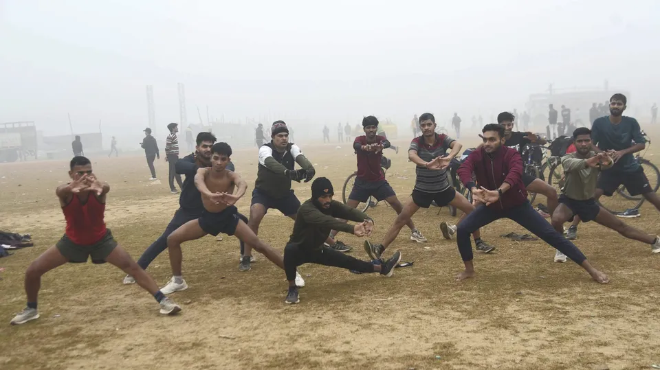 Youngsters during exercise on a foggy and cold winter day